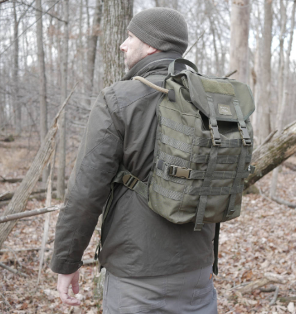 Influencer Everyday marksman standing in a forest with a Savotta Jääkäri backpack on his back.