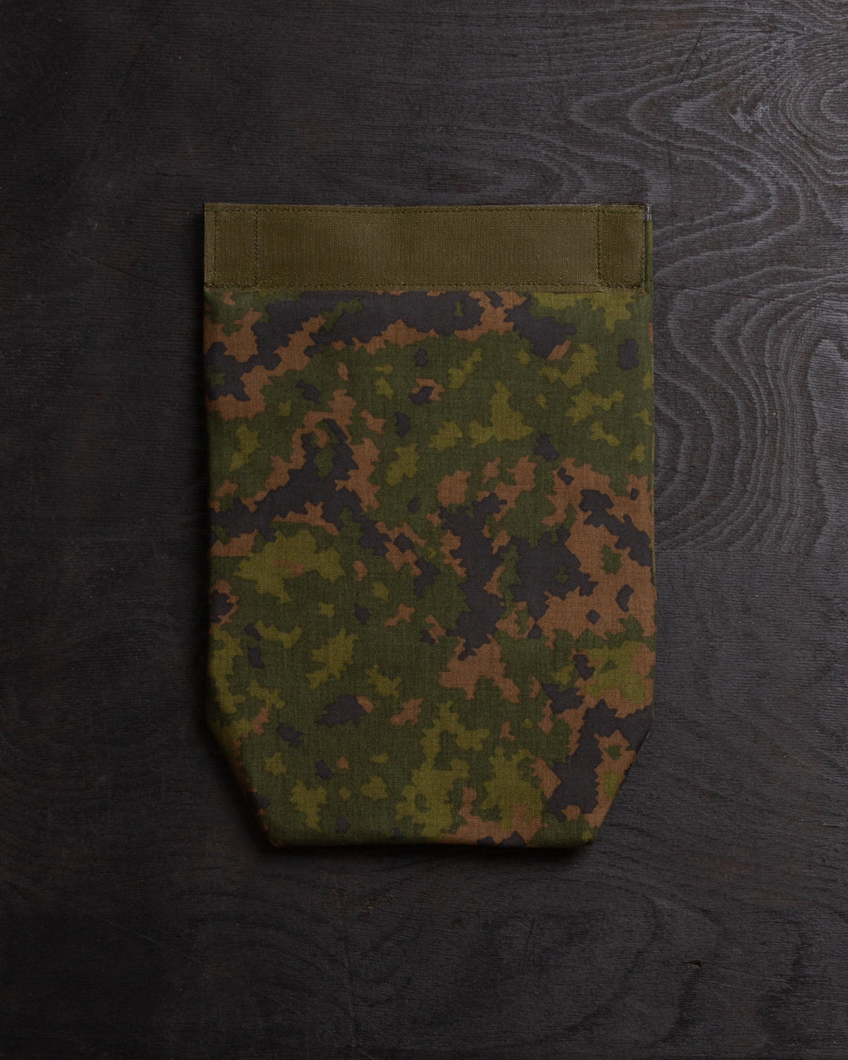 Savotta Varjelus groin flap from the back on a dark wooden surface