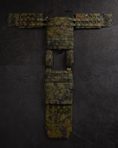 Savotta Varjelus groin flap attached to the opened up Savotta plate carrier on a dark wooden surface
