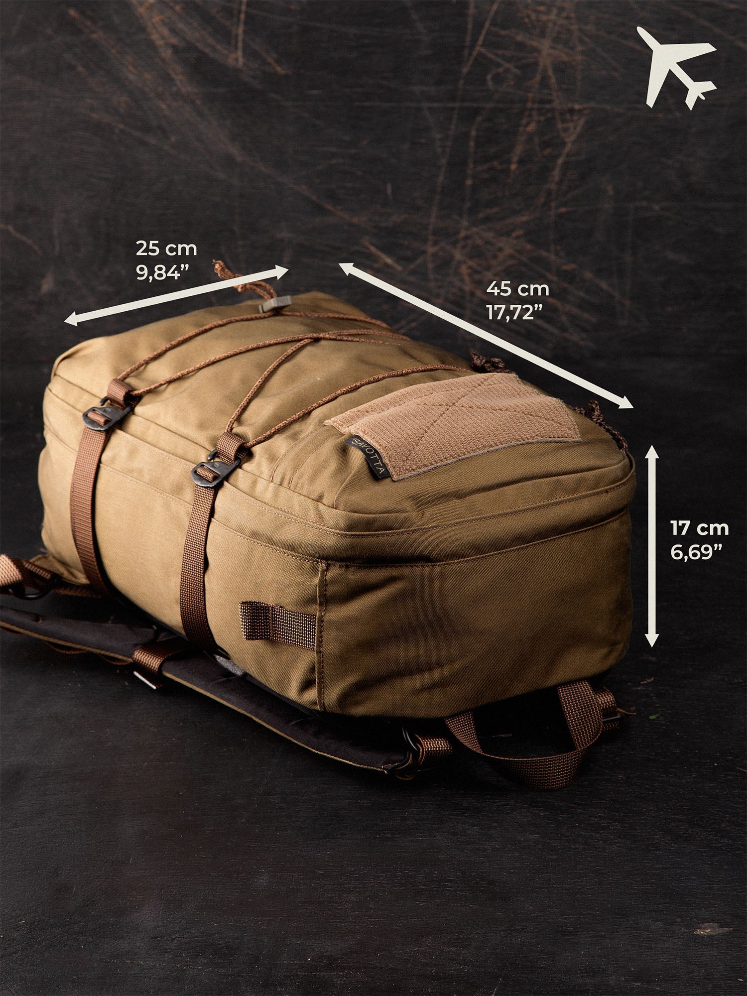 Brown Savotta Niukka 20L backpack with measurements for an airplane on a dark background