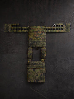 Savotta Varjelus plate carrier with cummerbunds attached, spread open a dark wooden surface