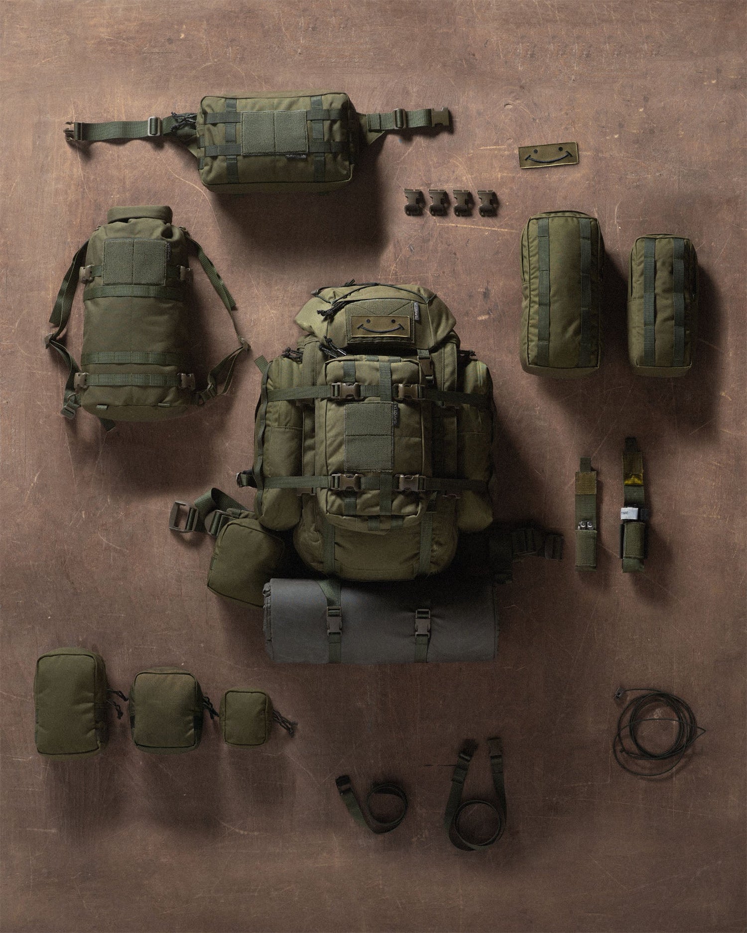 Savotta Kantamus 40L and a collection of all accessories on a brown wooden surface