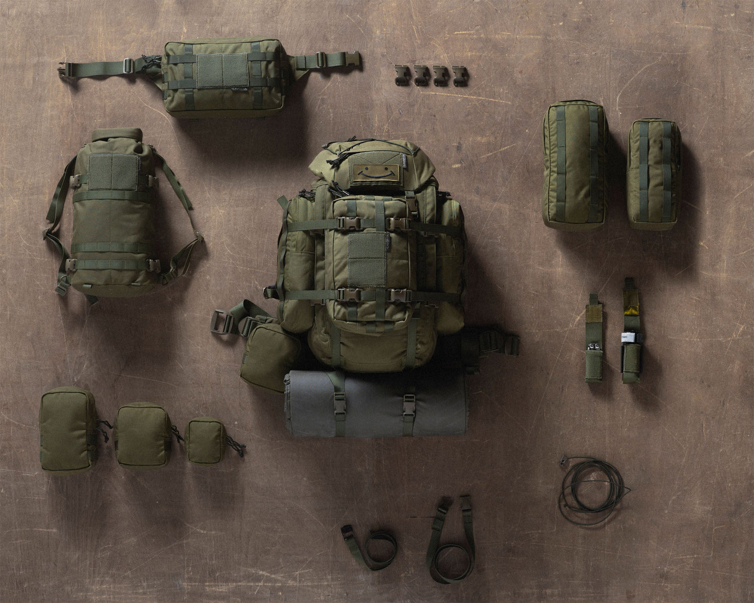 Savotta Kantamus 40L and a collection of all accessories on a brown wooden surface