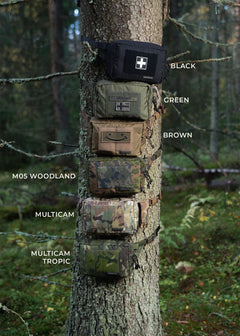 Six Savotta suur-kukkaros attached around a tree in a forest and showing the six different colour variants of the hip packs