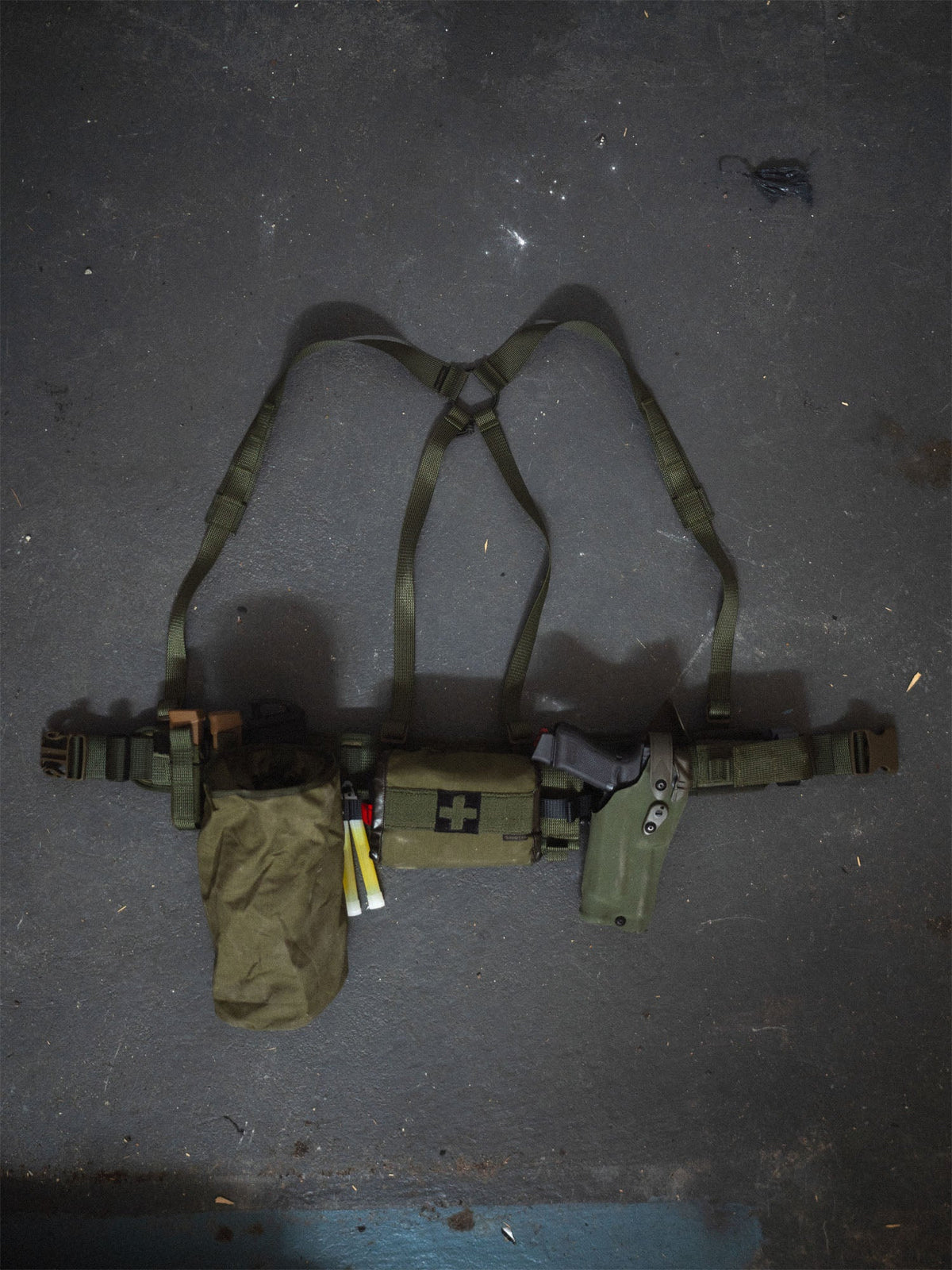 Savotta Valjas EX-harness attached to a Savotta Valjas combat belt on a floor with Savotta dump pouch and a Savotta S_IFAK vertical mount attached to the belt