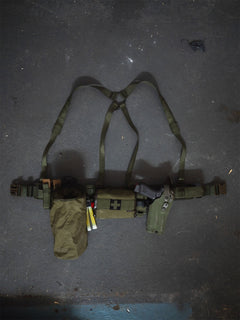 Savotta Valjas EX-harness attached to a Savotta Valjas combat belt on a floor with Savotta dump pouch and a Savotta S_IFAK vertical mount attached to the belt