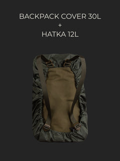 Savotta Hatka 12L backpack covered with a Savotta backpack cover 30L on a dark background.