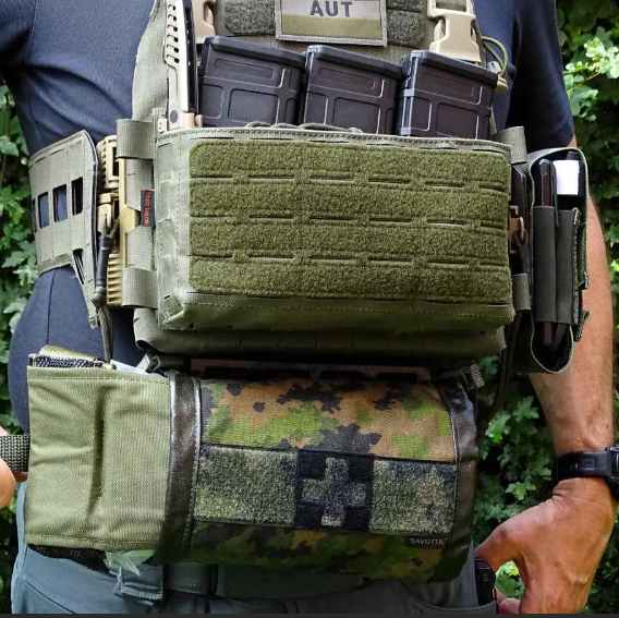 Person wearing a tactical vest with Savotta S-IFAK and equipment.