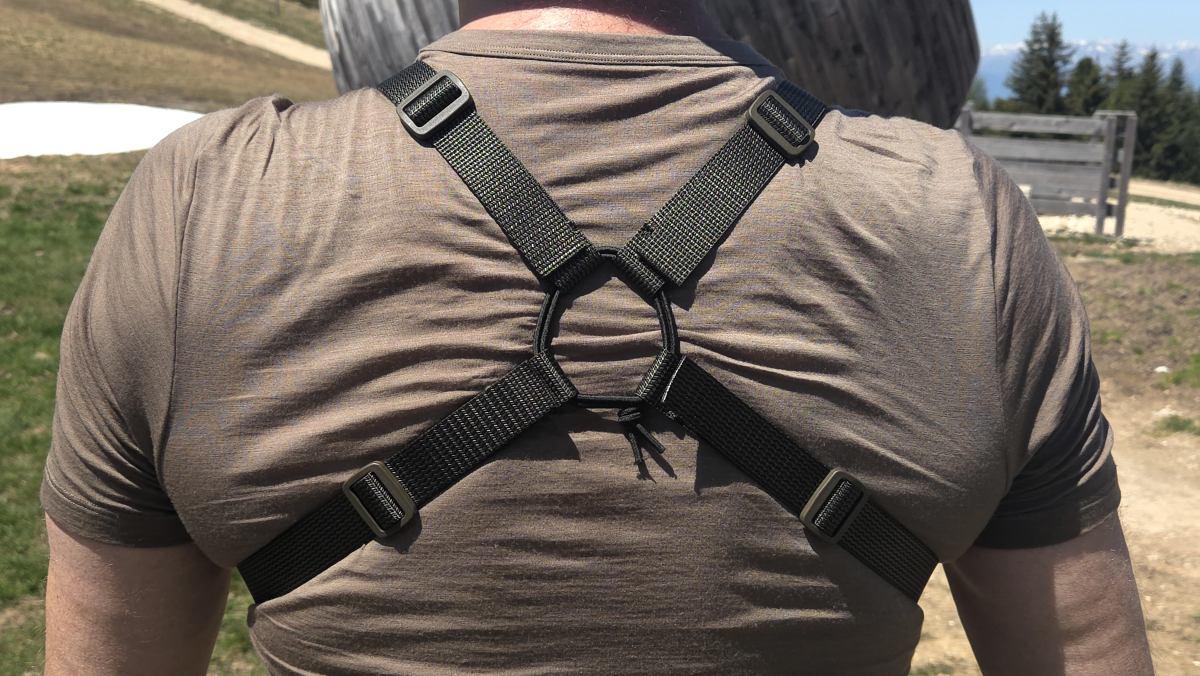Person wearing a Savotta Rintamus chest pack, showing the back, on a natural background
